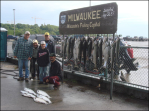 group of 5 in front of their large catch of fish