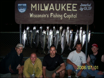 group of 5 kneeling in front of their fish