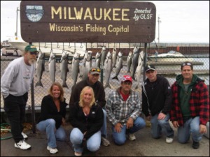group of 7 in front of their charter fishing catches
