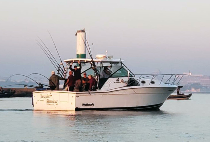 A 33 foot charter fishing boat named Trophy Hunter on Lake Michigan with a group of anglers from Reel Sensation